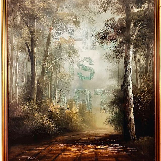 This is Art, piece of embroidery art by Niamh Wimperis. A painting of a forest scene with the words This Is Art embroidered on top.